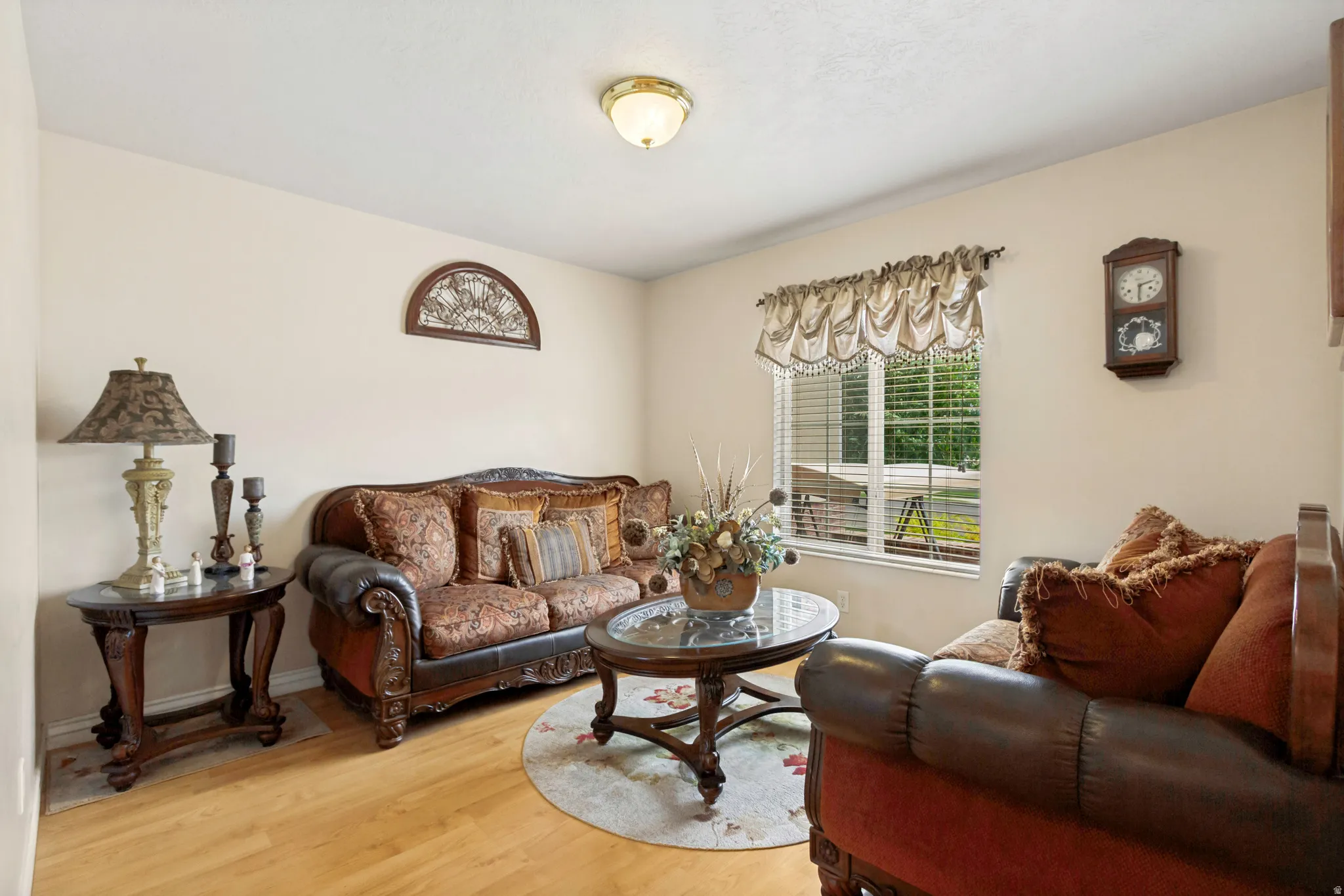 Living area featuring light-toned walls and wood-finish flooring