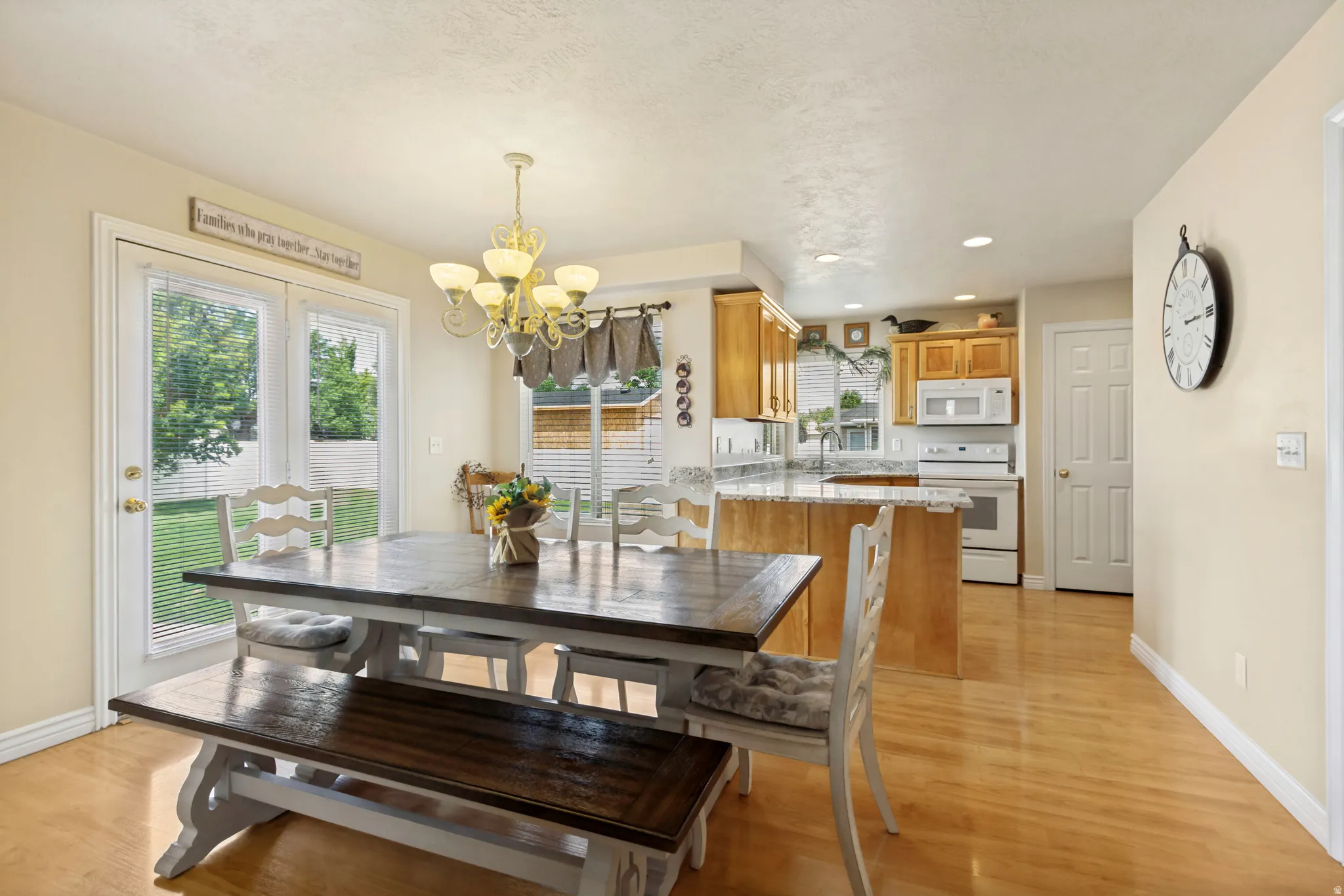 Dining area featuring wood-finish flooring and a brass chandelier