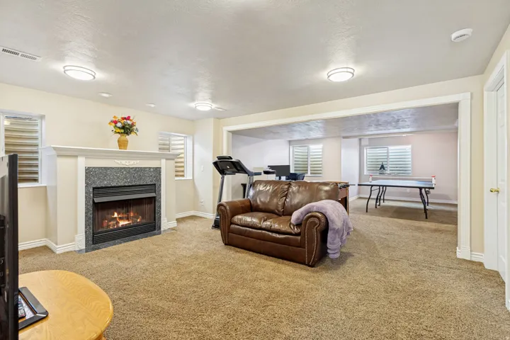 Living area featuring a fireplace with a granite surround and a white mantle
