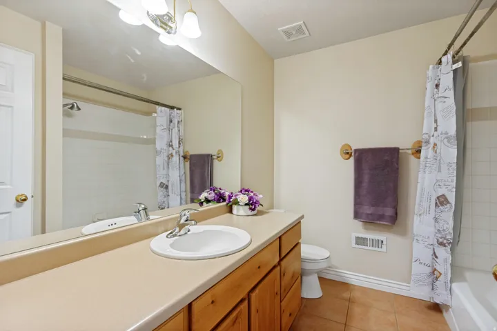 Full vanity with an integrated sink, polished chrome faucet, and wood-finish cabinetry