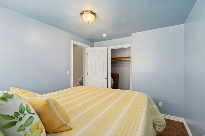 Bedroom featuring light blue walls and a textured blue ceiling