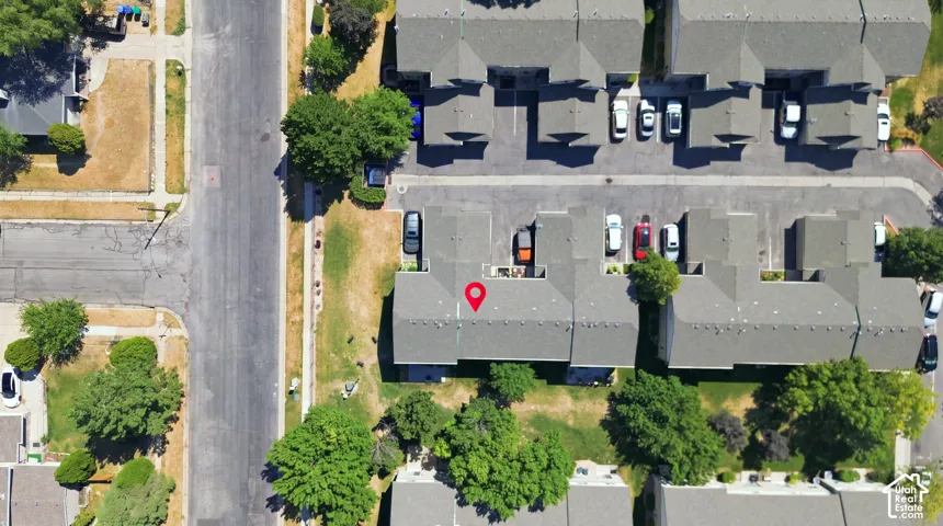 Aerial view showcasing a well-organized multi-unit residential complex with dedicated parking spaces, mature landscaping throughout the grounds, and efficient layout design