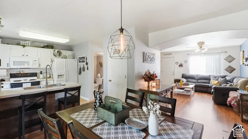 Open-concept living space featuring wood-finish flooring