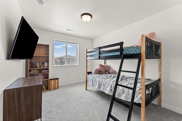 Carpeted room featuring a single window, built-in ceiling light, and light-colored walls