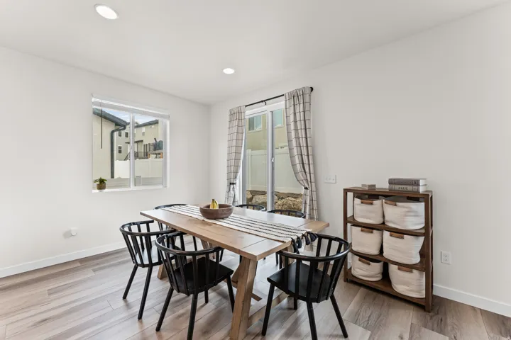 Dining area featuring light wood-finish flooring, recessed lighting, and a sliding glass door