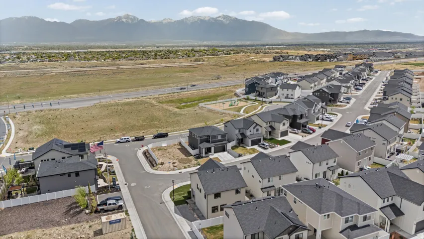 Aerial perspective showcasing a structured residential development with mountain backdrops