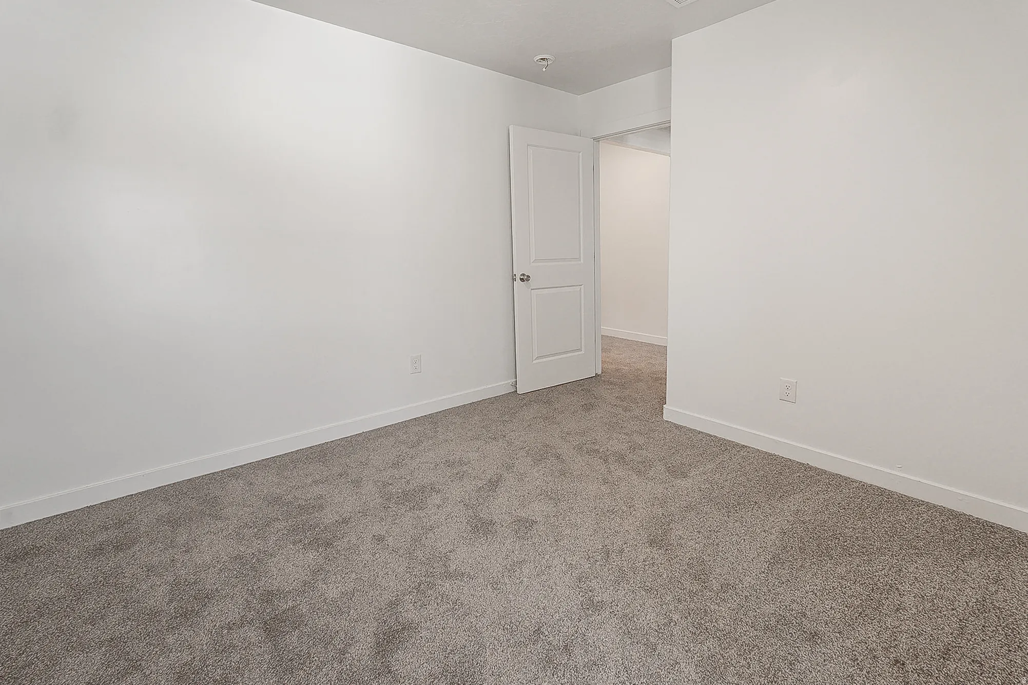 Room featuring neutral gray carpeting and white painted walls