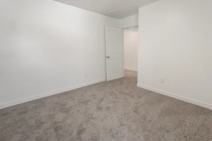 Room featuring neutral gray carpeting and white painted walls