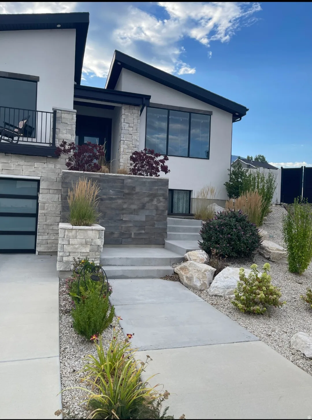 Modern architectural exterior featuring a striking design with contrasting white and charcoal finishes