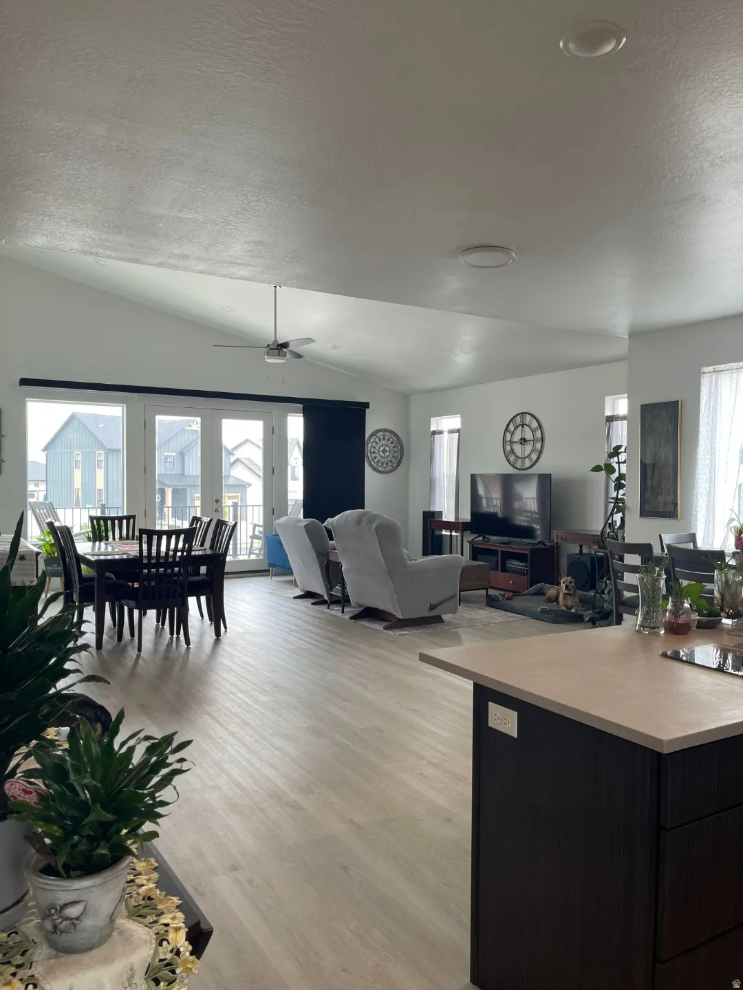 Open-concept living space featuring wood-finish flooring throughout, recessed ceiling lighting, and a ceiling fan