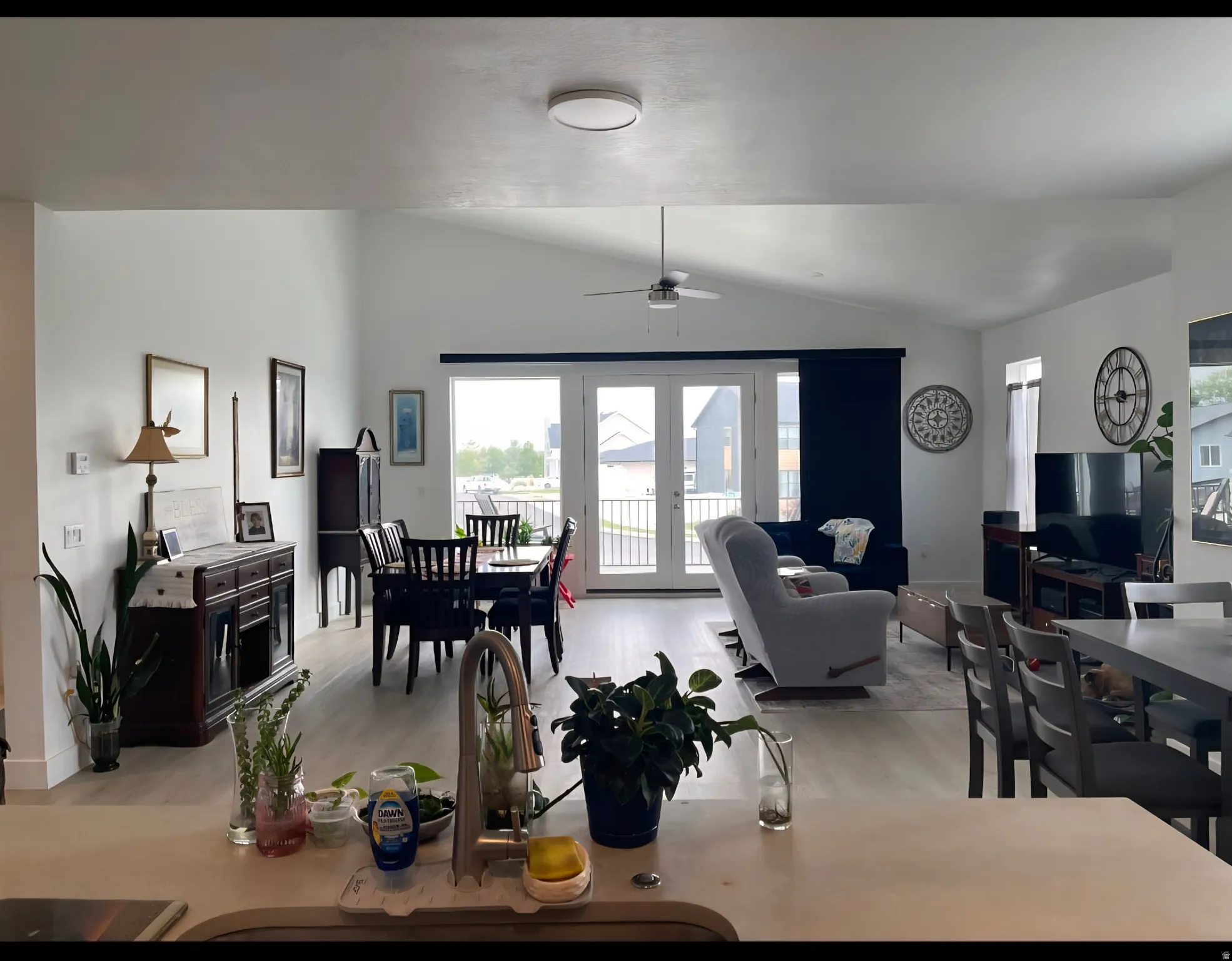 Open-concept living space featuring vaulted ceilings and light wood-finish flooring
