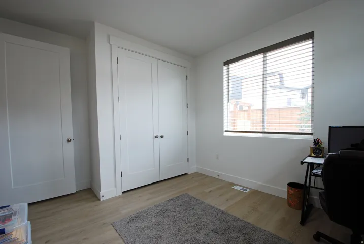 Wood-finish flooring with white walls and trim