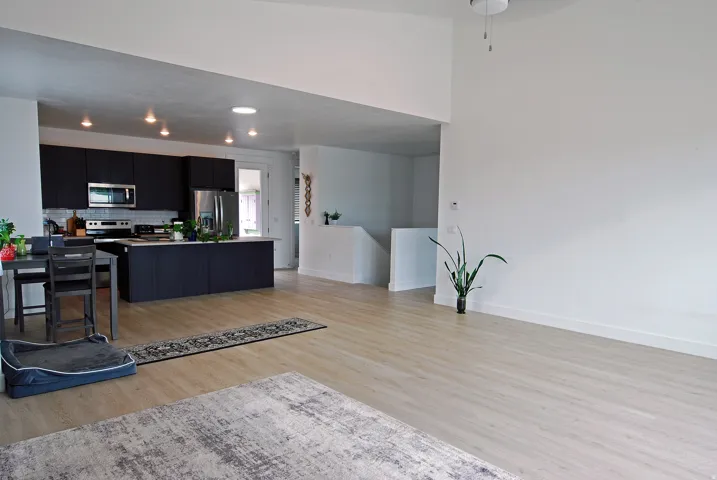 Open-concept living space with light wood-finish flooring