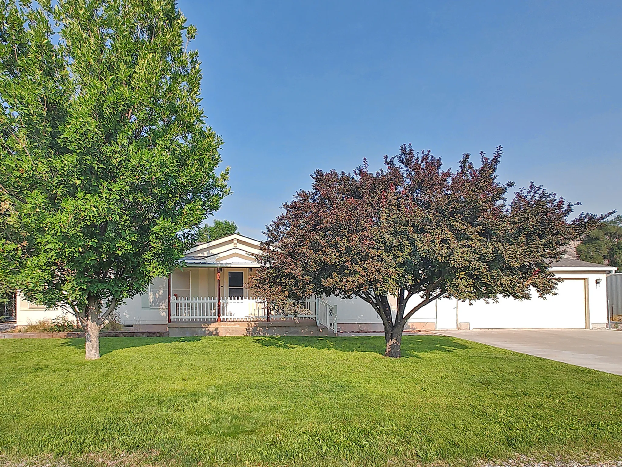 Charming single-story home situated on a spacious landscaped lot featuring mature shade trees and lush lawn