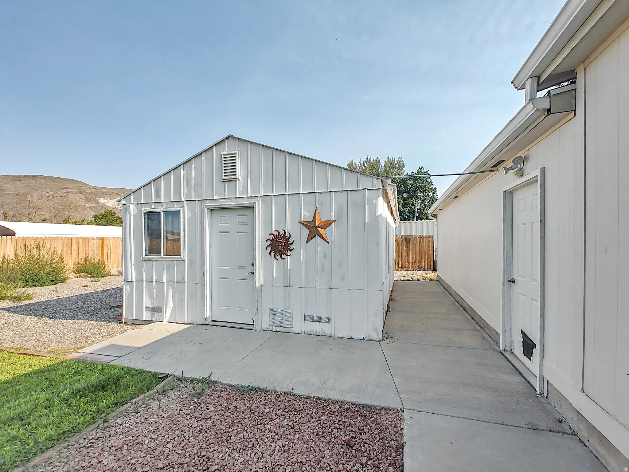 Exterior of large storage shed in backyard.
