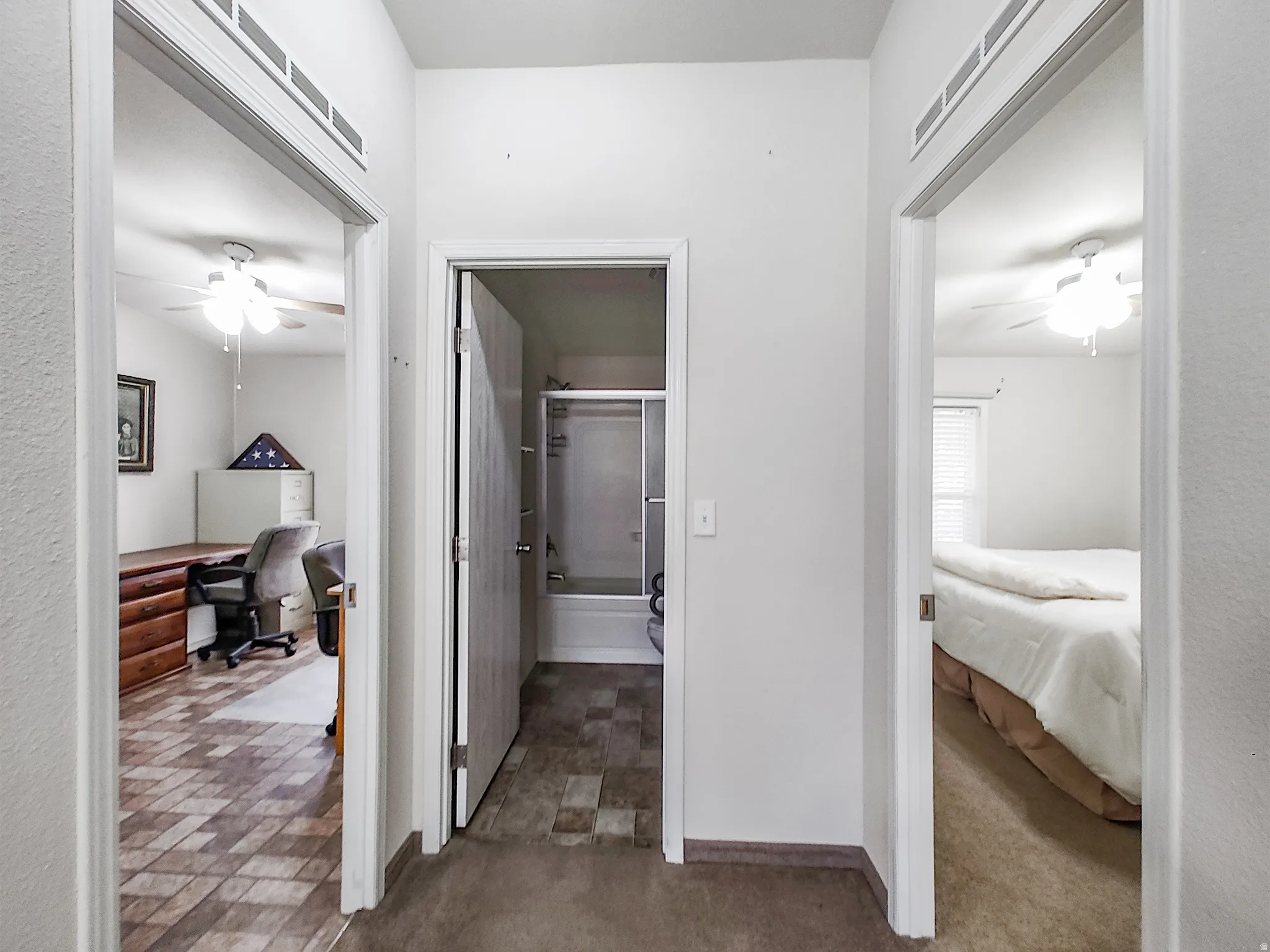 Hallway featuring light-colored walls and carpet flooring