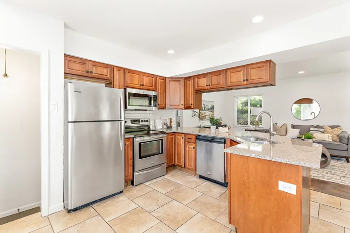 Kitchen featuring wood cabinetry, stainless steel appliances, and a light-toned countertop