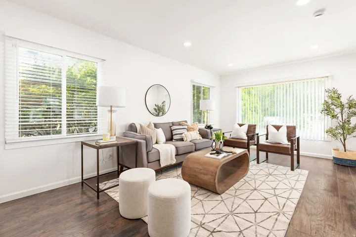 Bright living space featuring wood-finish flooring and recessed lighting