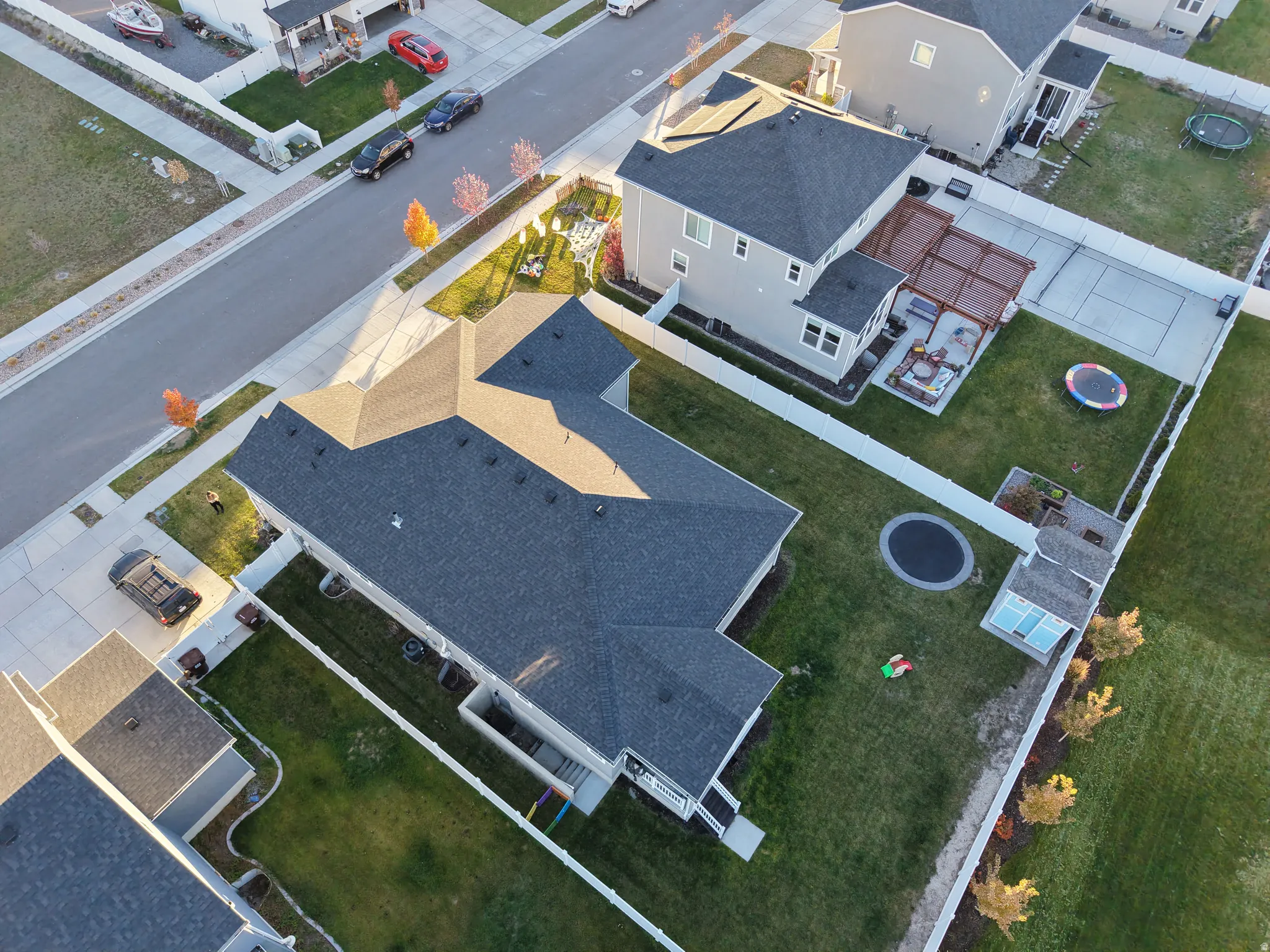 Expansive property featuring a large private yard with a manicured lawn, an inground trampoline, and a detached shed structure