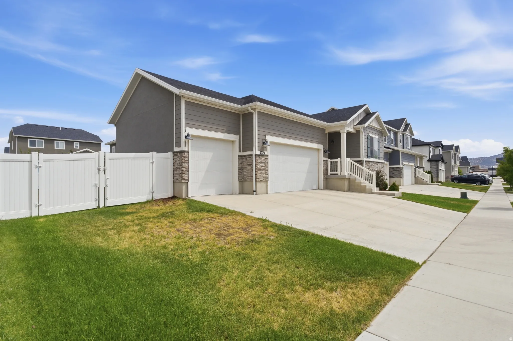 Neutral-toned exterior with horizontal siding and stone accents