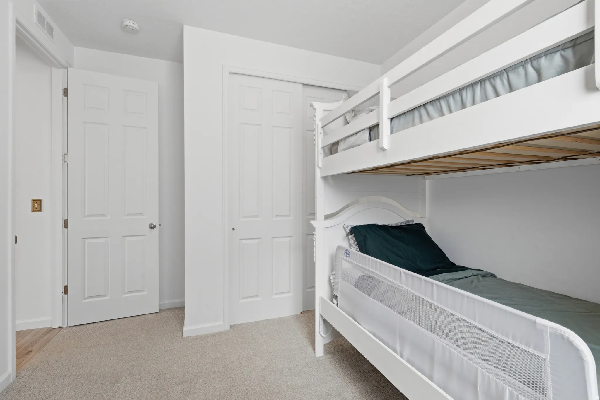 Plush carpeting, interior paneled doors, and a sliding closet door