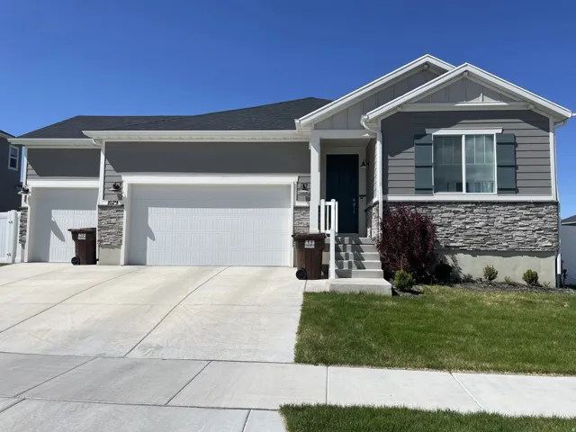 Contemporary exterior featuring gray siding and a stone facade