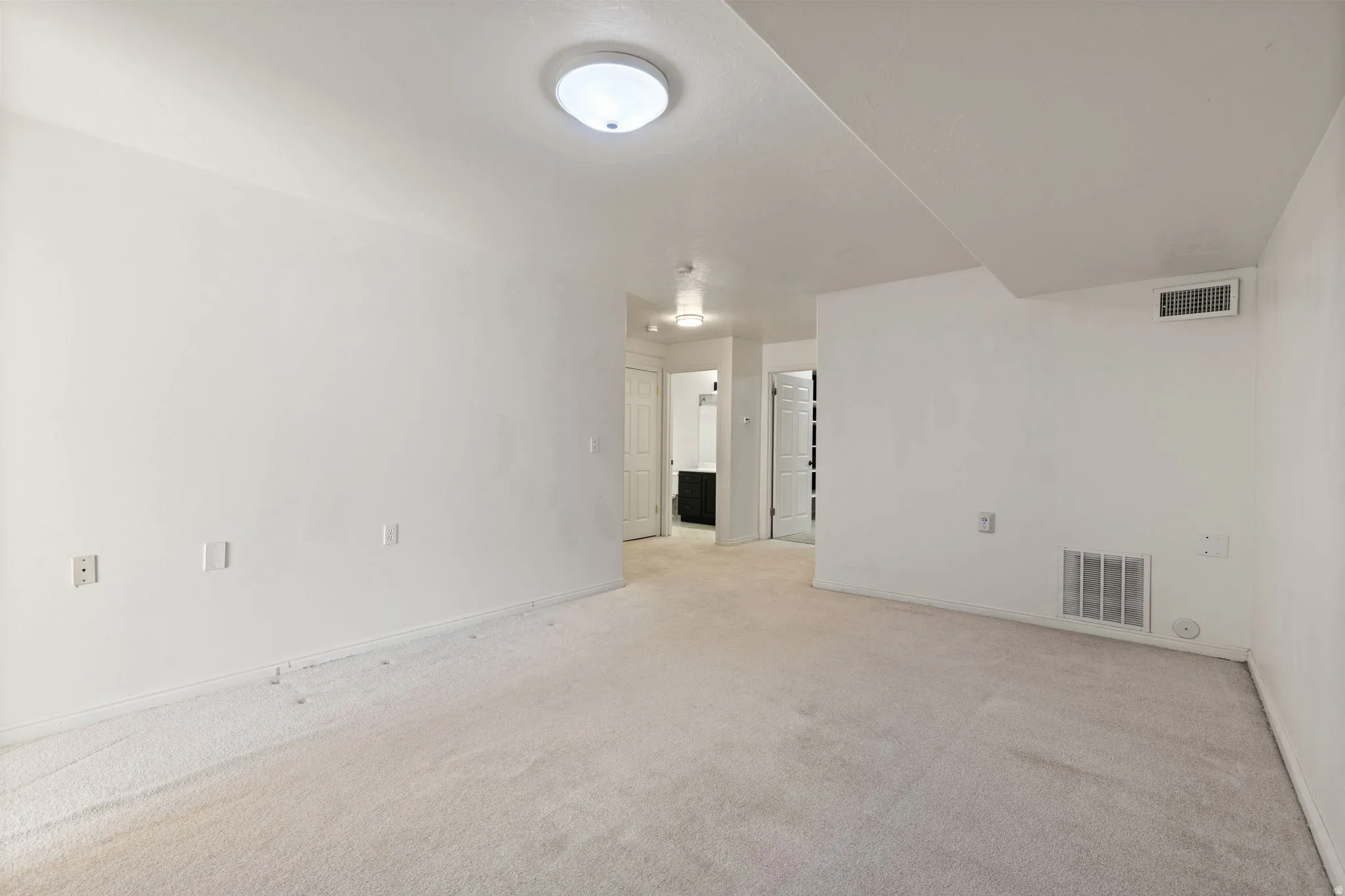 Recessed lighting and warm white walls create a neutral palette