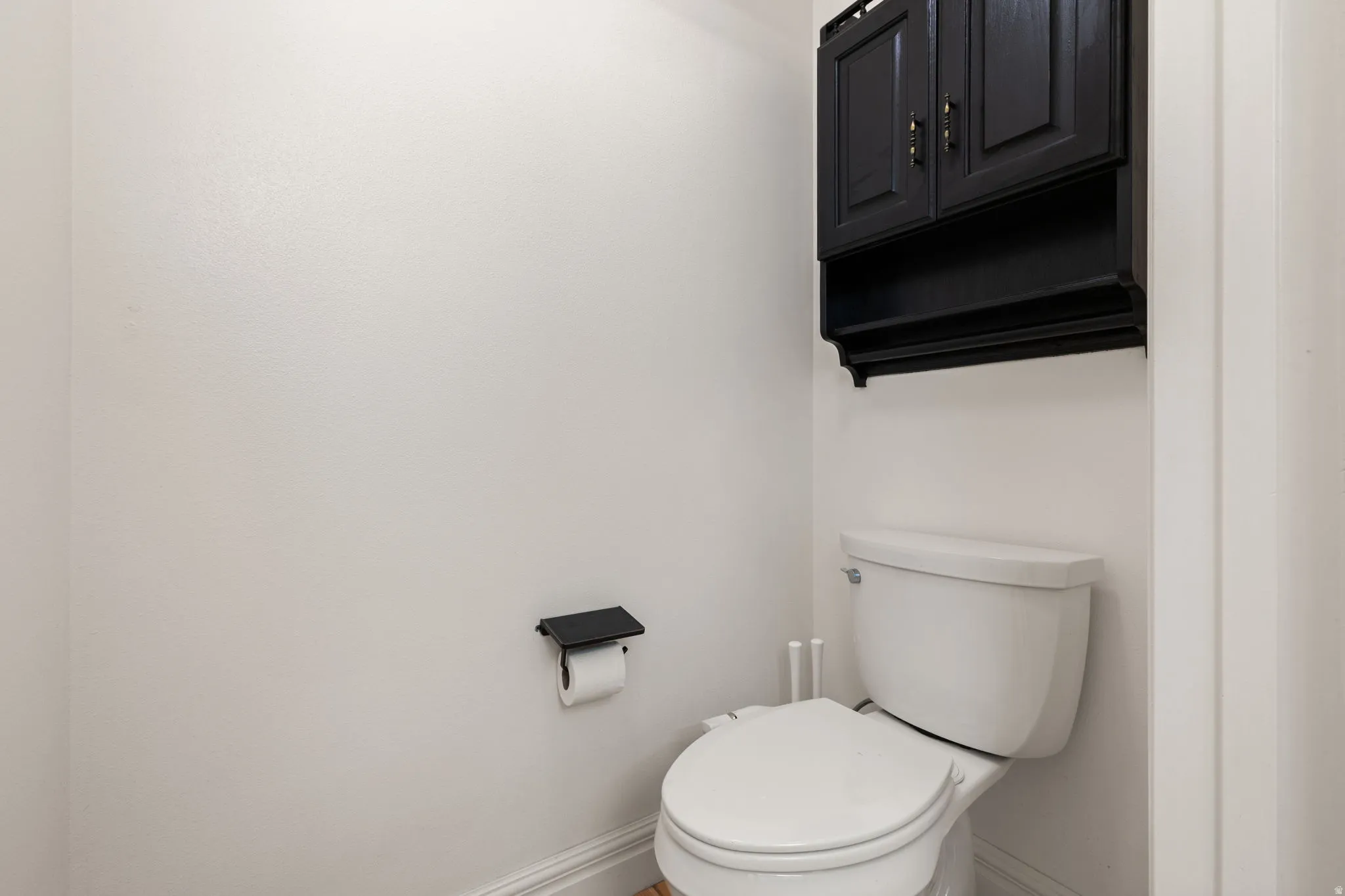 Built-in cabinetry with dark finish and gold-tone hardware