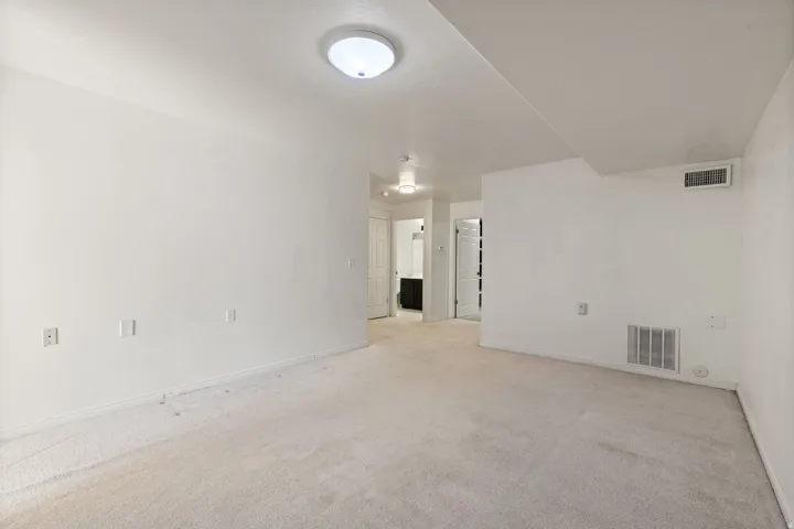 Recessed lighting and warm white walls create a neutral palette