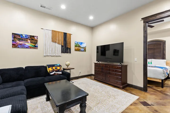 Interior space featuring light-toned walls, recessed lighting, and a light-colored area rug over a patterned floor