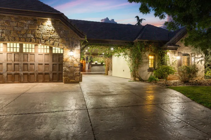 Stone-clad exterior featuring a multi-panel garage door with transom windows