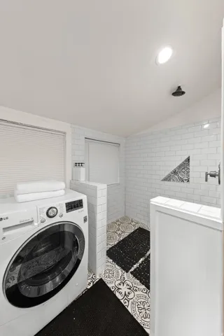 Dedicated laundry area featuring a front-load washing machine