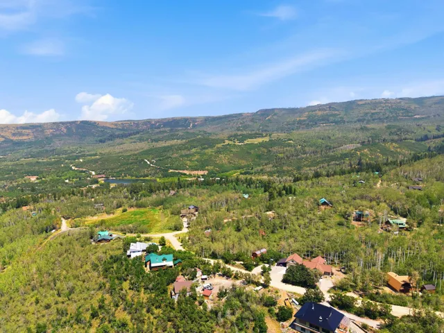 Expansive mountain landscape featuring varied terrain and abundant tree coverage