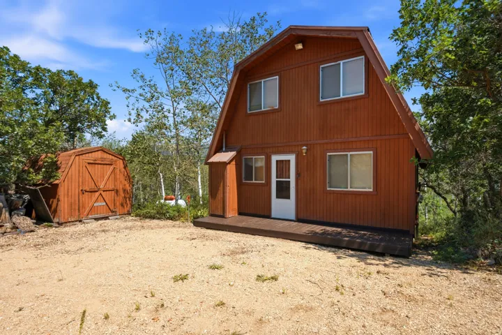 Barn-style dwelling featuring wood siding and a ground-level deck