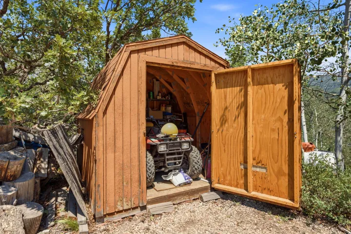 Wood-sided storage shed with a gambrel roof