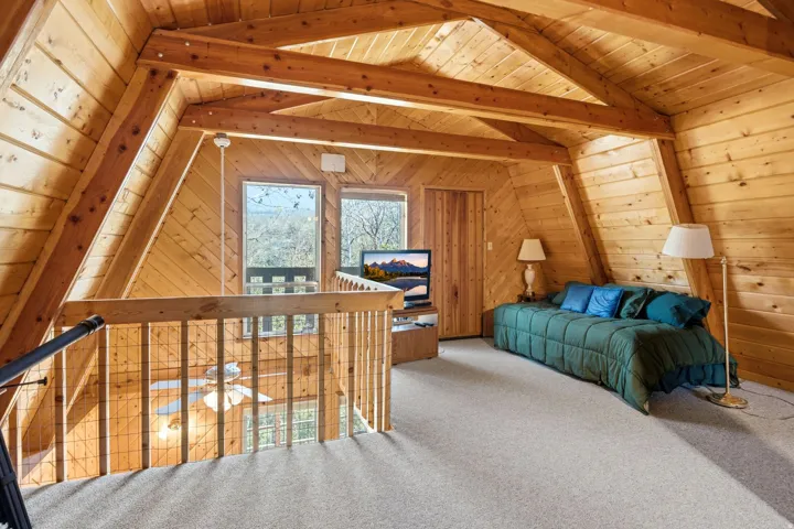 Vaulted wood-paneled ceiling with exposed beams
