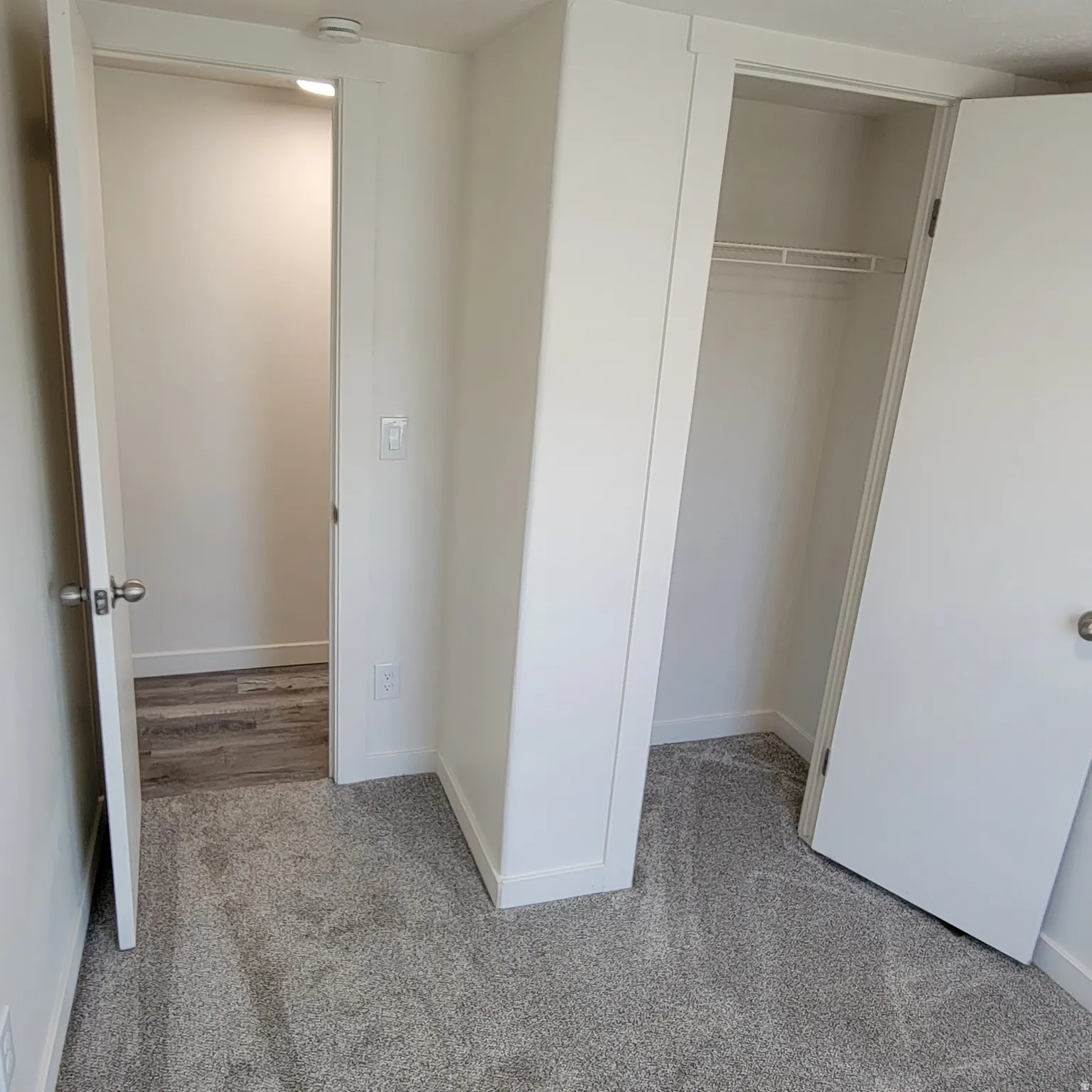 Plush gray carpeting throughout the room