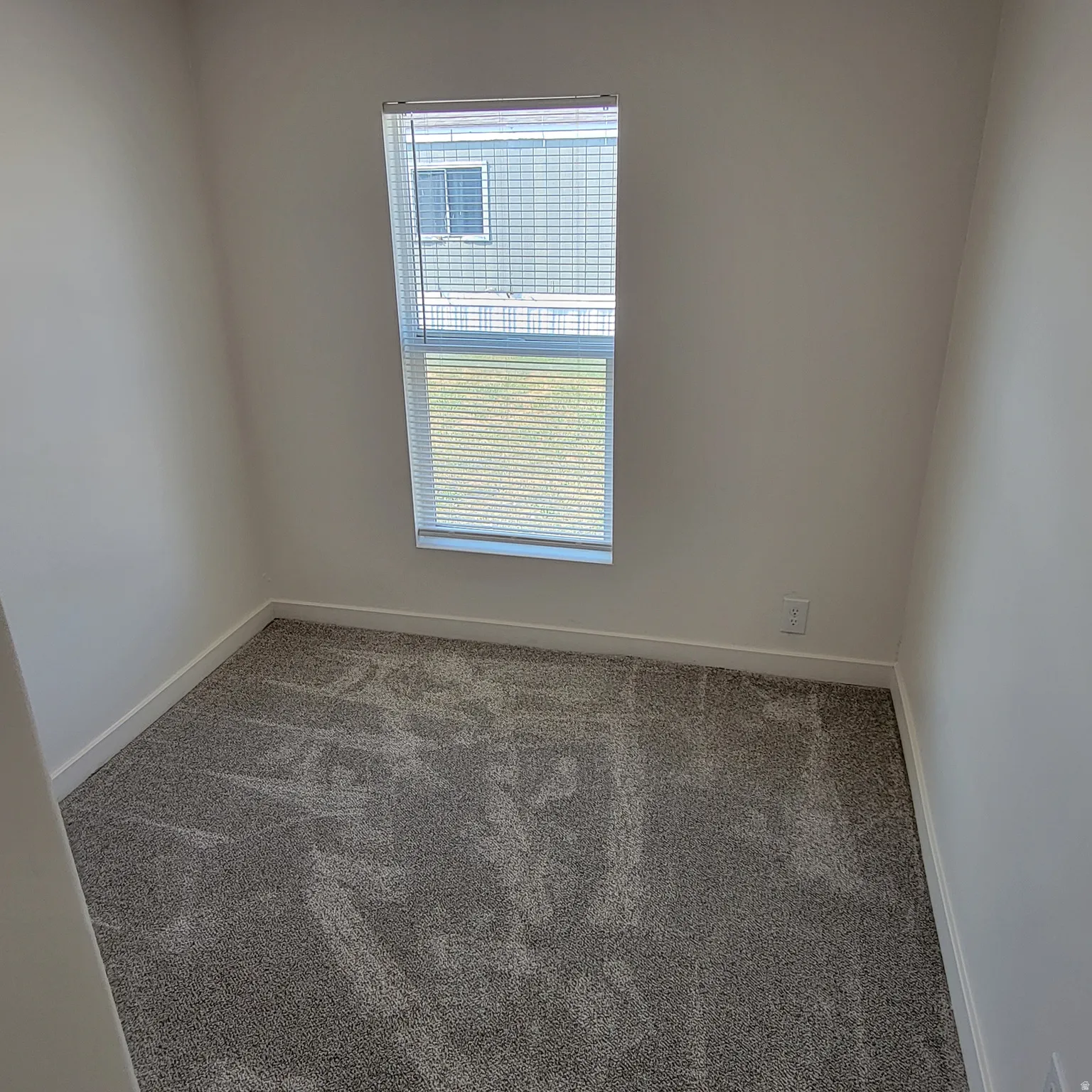 Neutral-toned carpeting paired with crisp white baseboards