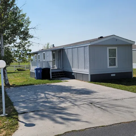 Light blue siding with dark gray skirting and trim