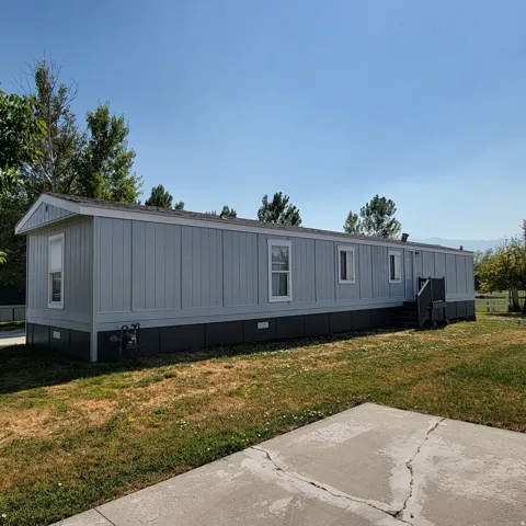 Light blue siding exterior with white trim and dark foundation