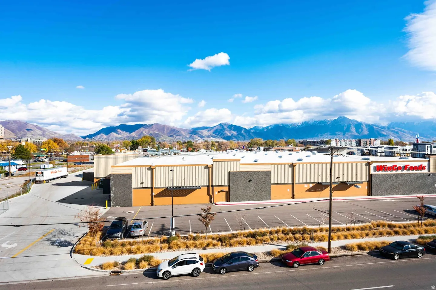 Commercial building featuring a large parking area, loading docks, and distinct WinCo Foods branding