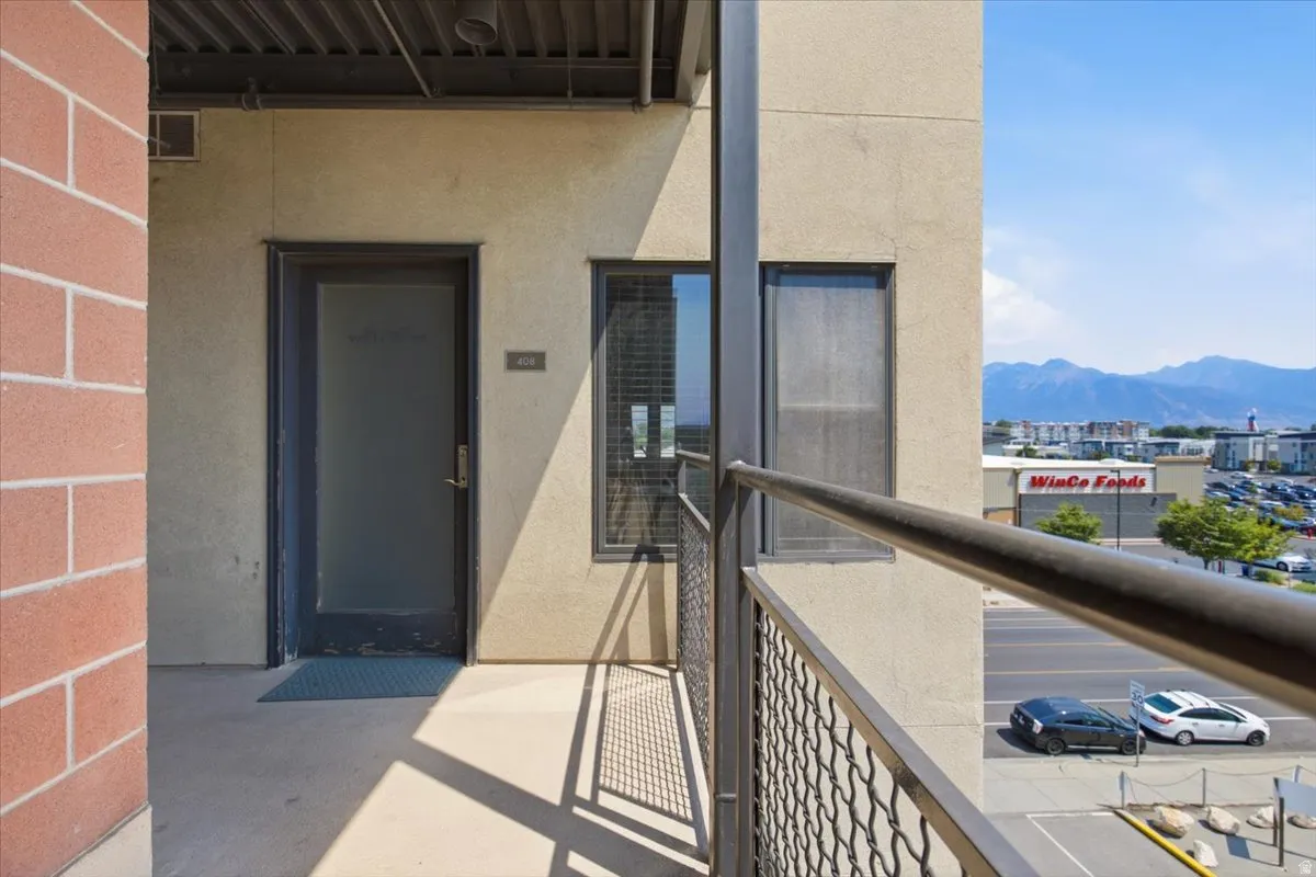 Private balcony with a metal railing and mountain backdrop