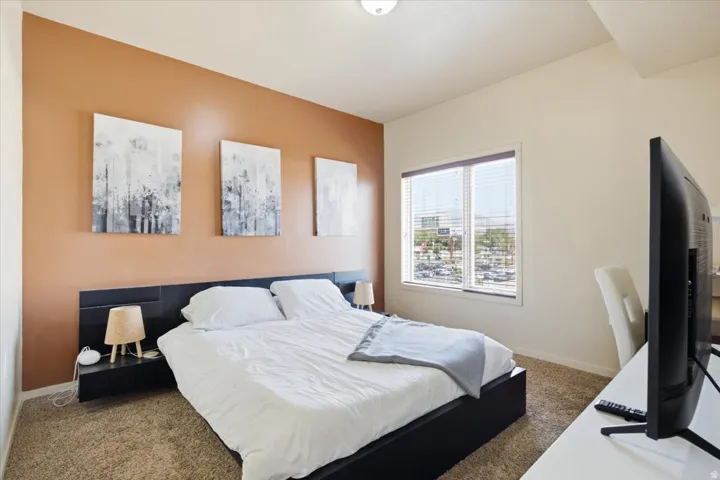 Carpeted interior space featuring a single window with blinds
