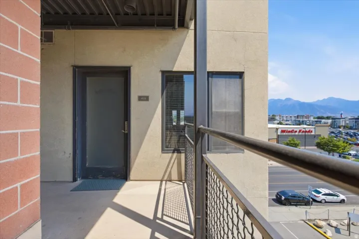 Private balcony with a metal railing and mountain backdrop