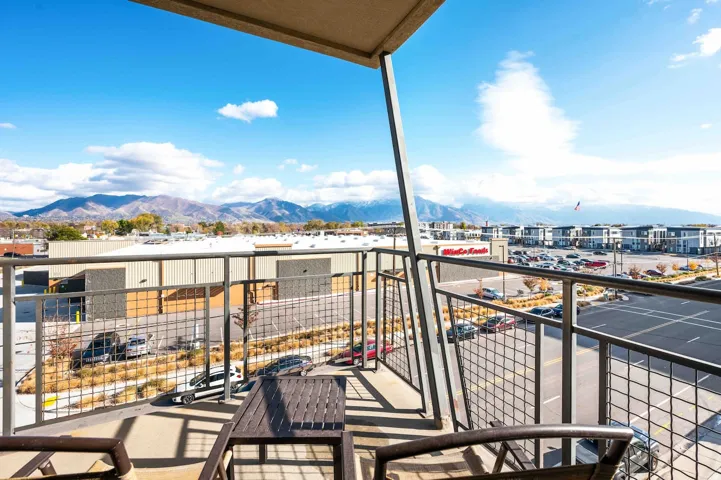 Private balcony with metal grid railings and mountain backdrop