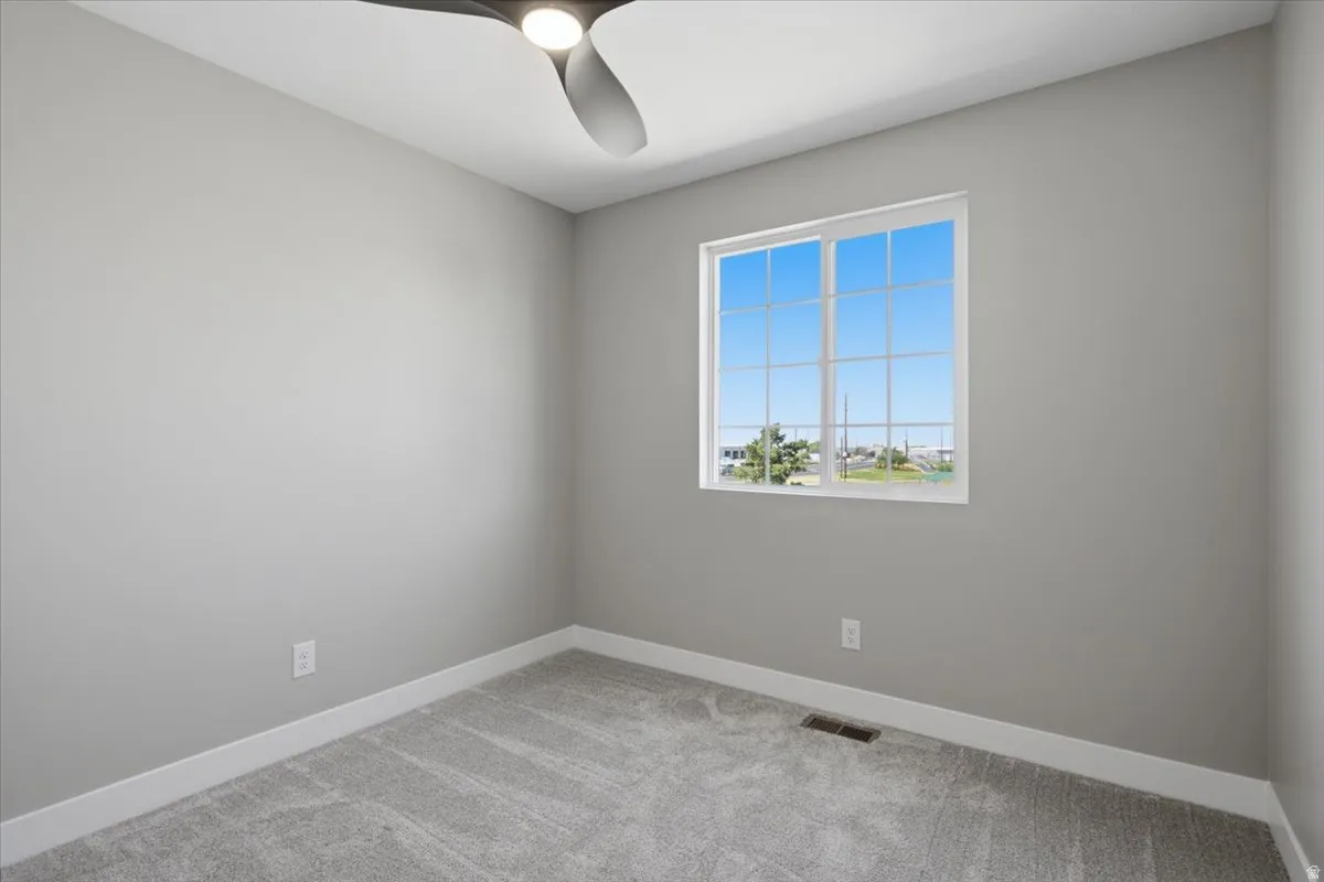 Neutral gray walls with white trim, featuring a large window with grid pattern