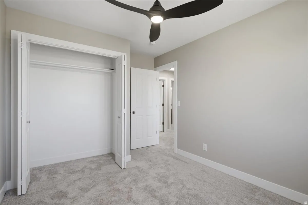 Bedroom featuring light gray wall paint, gray carpet flooring, and white trim