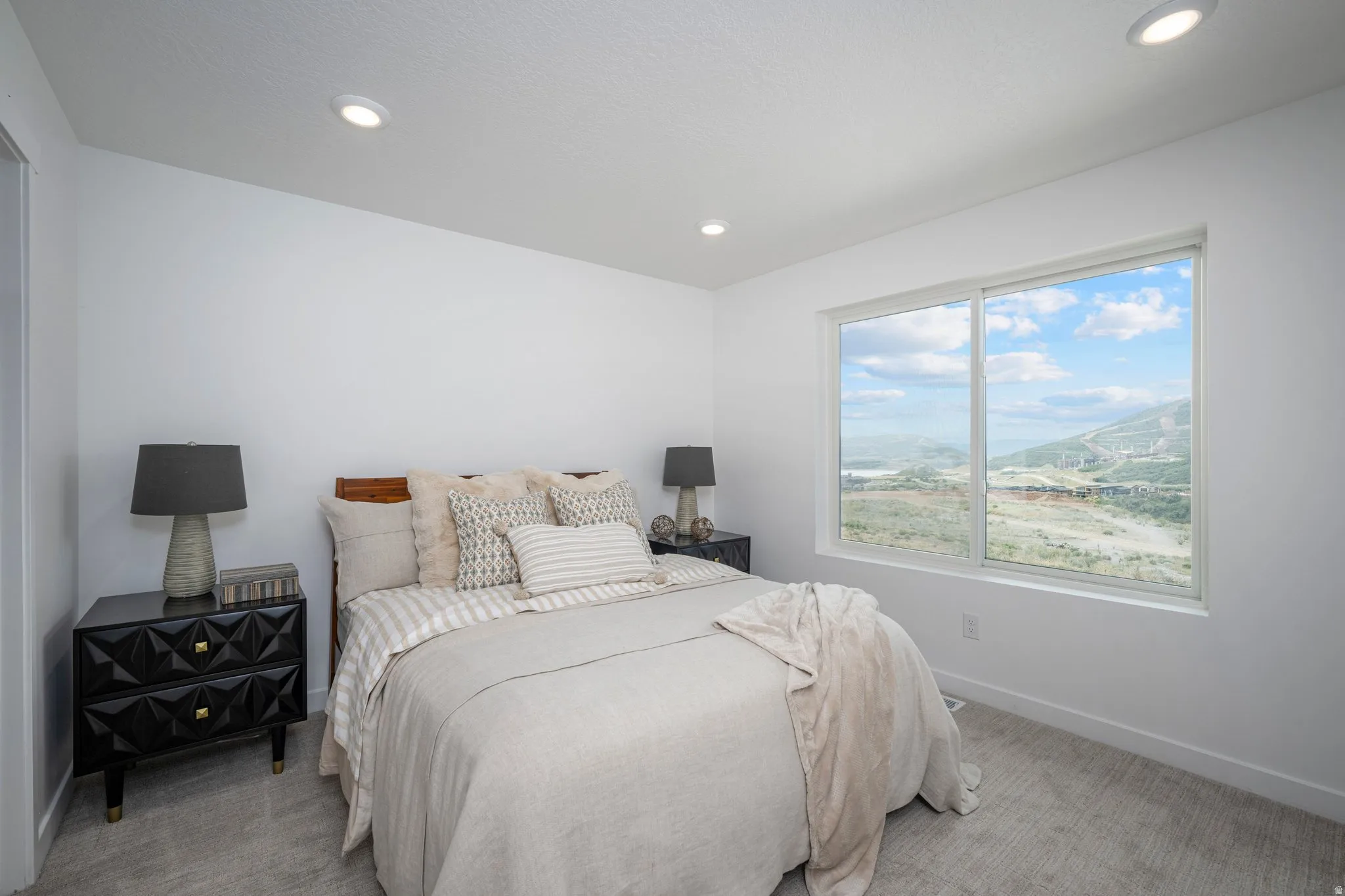 Bedroom featuring a large picture window, recessed lighting, and light-toned carpeting