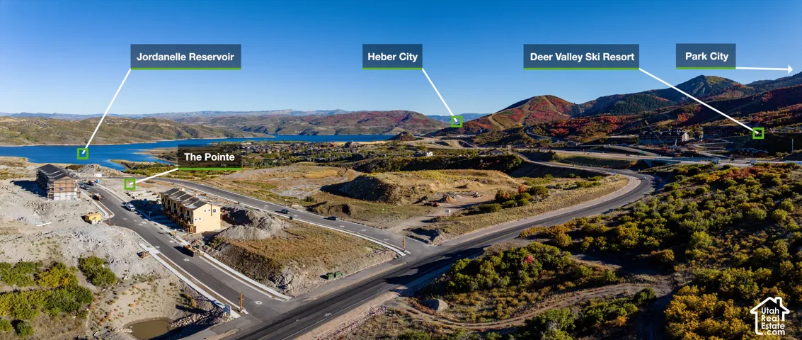 Expansive undeveloped land with paved roadways and distant water body