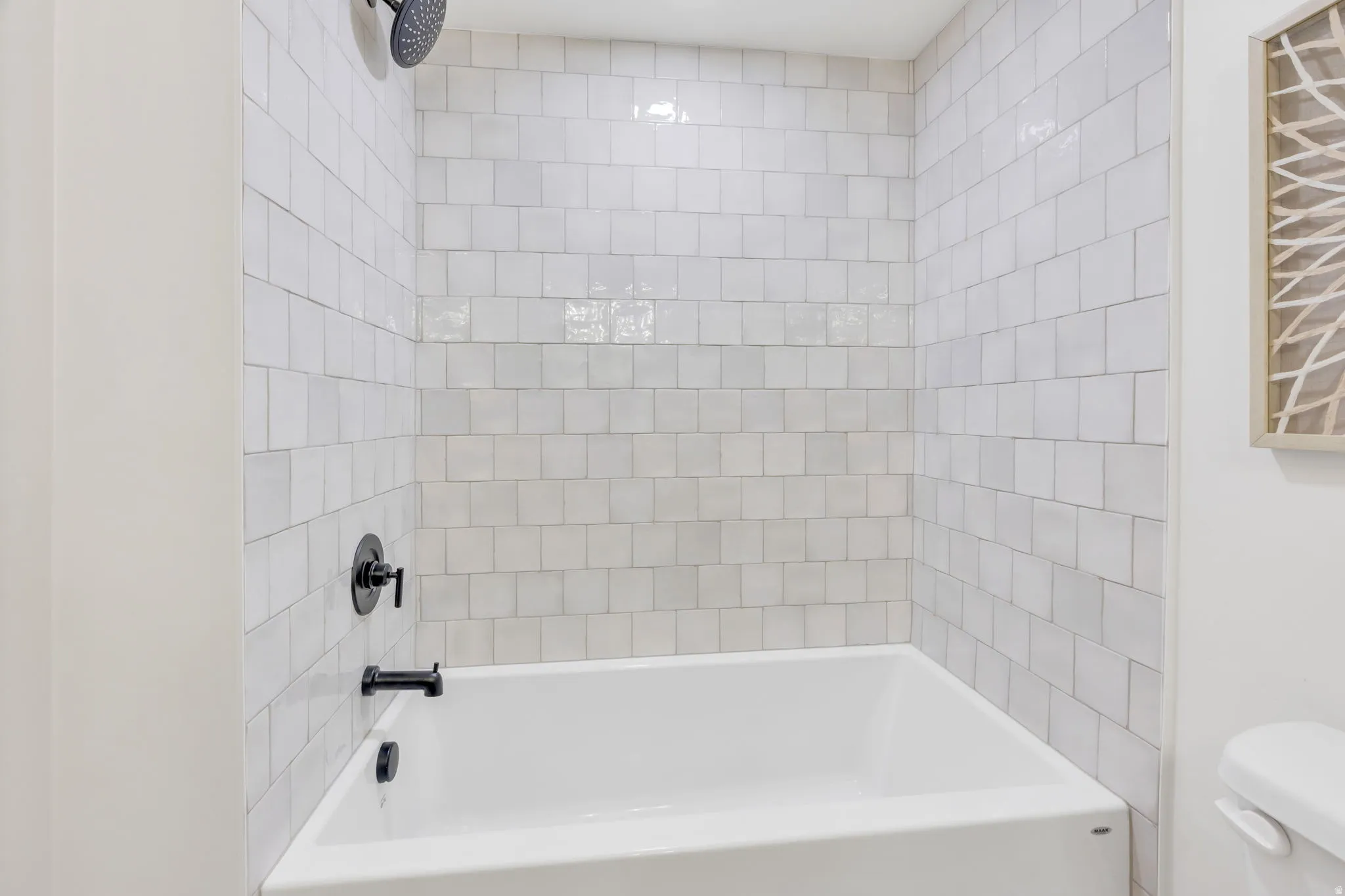 Bathtub and shower combination featuring matte black fixtures